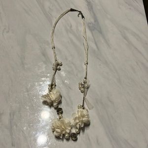 White necklace with flowers and pearls